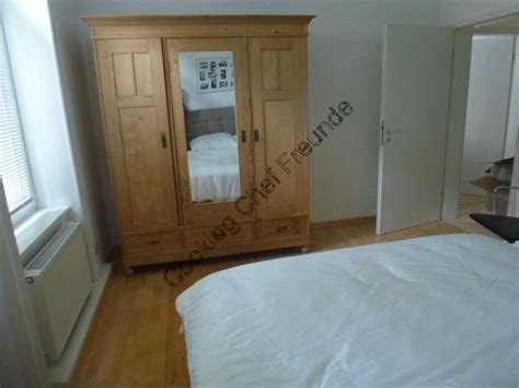 An Empty Bedroom With A Bed Dresser And Mirror In It S Center Area