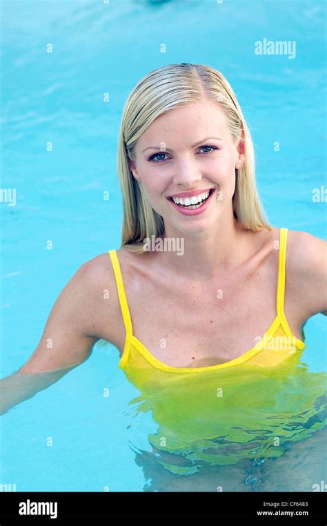 Female Long Straight Blonde Hair Wearing Yellow Vest Top And Bikini