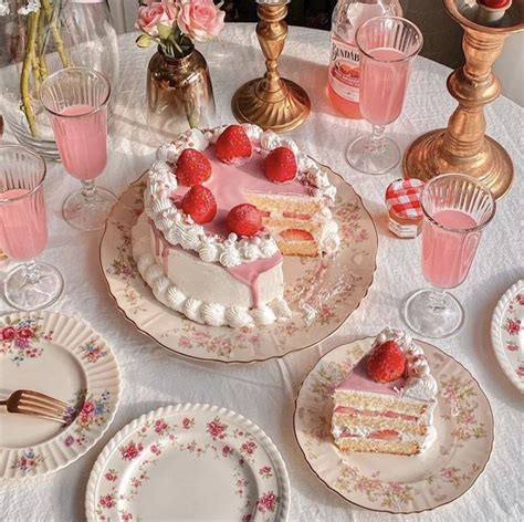 A Table Topped With Plates And Cake Covered In Frosting