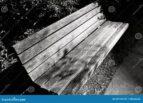 Grayscale Closeup Of An Empty Old Wooden Bench In The Park Stock Image