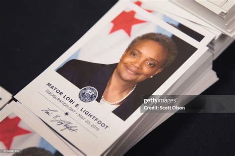 Cards With A Picture Of Mayor Lori Lightfoot Are Passed Out To News