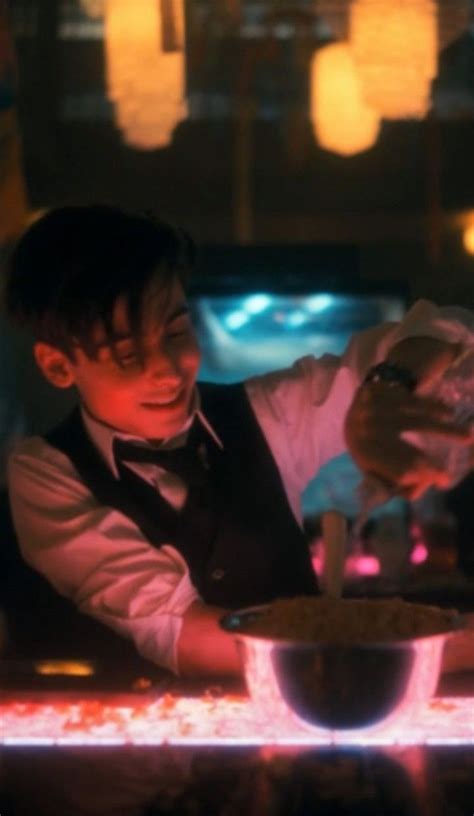 A Man Pouring Something Into A Bowl On Top Of A Counter