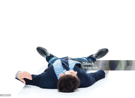 Handsome Businessman Knocked Out On The Ground Stock Photo Download