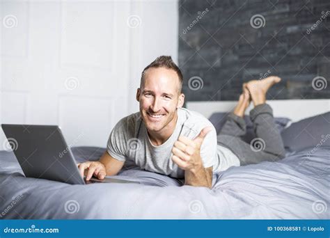 Serious Casual Young Man Using Laptop in Bed at Home Stock Image ...