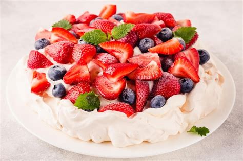 Premium Photo Delicious Pavlova Cake With Fresh Strawberry And Blueberry