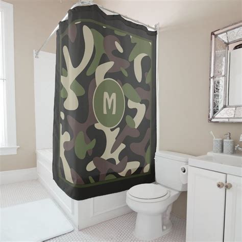 A Camouflage Shower Curtain With The Letter M On It Is Hanging In A