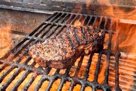 New York Steak On Grill With Fire Stock Photo At Vecteezy