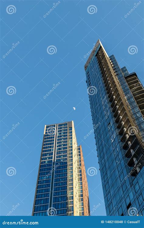 Two Tall Skyscrapers In Downtown Brooklyn Point Toward The Distant Moon