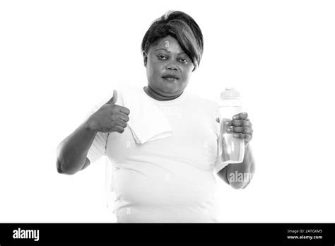 Fat Black African Woman Holding Water Bottle And Giving Thumb Up Ready