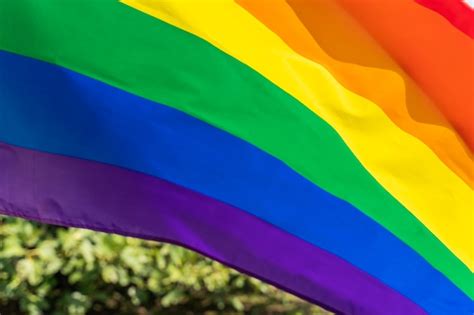 Premium Photo Rainbow Flag Lgbt Movement On The Sunny Blue Sky Background Colorful Gay Flag Waving