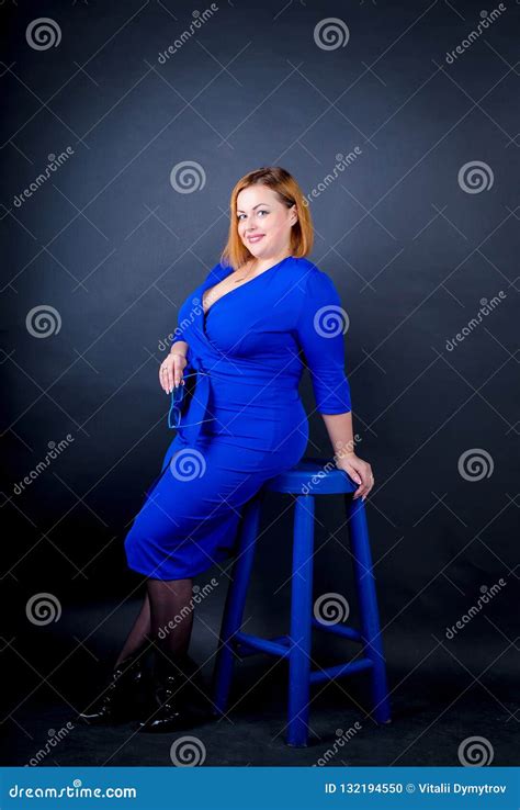 Beautiful Chubby Girl In Blue Elegant Dress On A Black Background