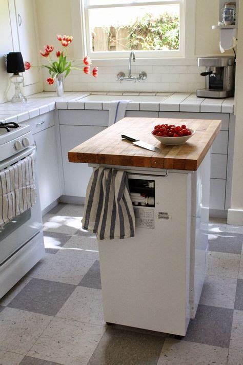 A Portable Dishwasher Kitchen Island With A Butcher Block Countertop And Holders Is A Functiona