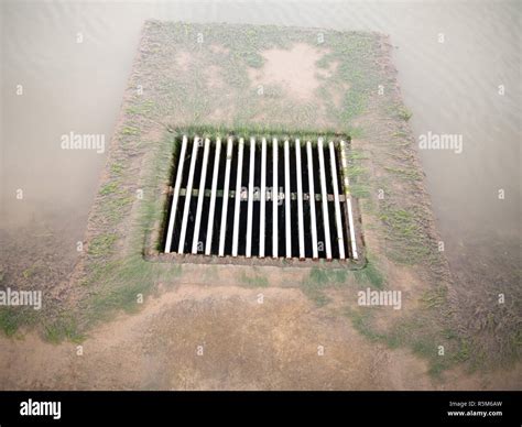 metal water grid  water running    ground clear stock photo