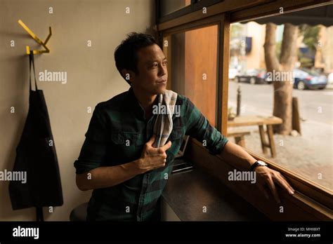 Thoughtful Man Looking Through Window Stock Photo Alamy