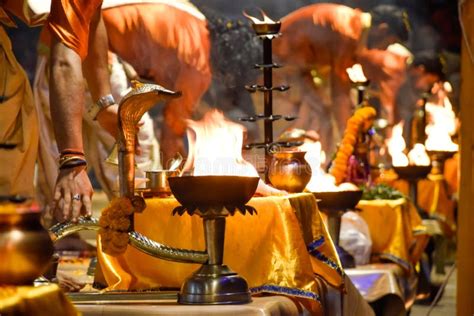 Pujaris Or Indian Priests Performing Aarti Ceremony On Banks Of Ganges