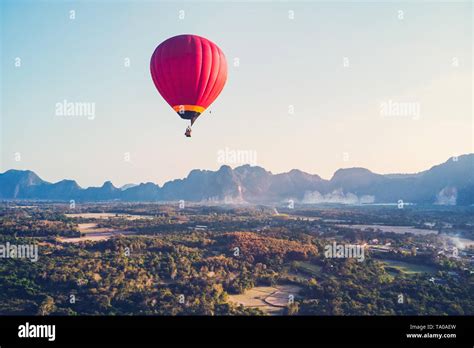 Red Hot Air Balloon Raising Just In Time To Explore The Beautiful Sunset Over Vang Vieng In Laos