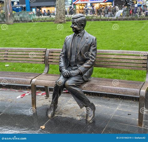 Statue Of Mr Bean Sitting On A Bench Rowan Atkinson Bronze Statue In