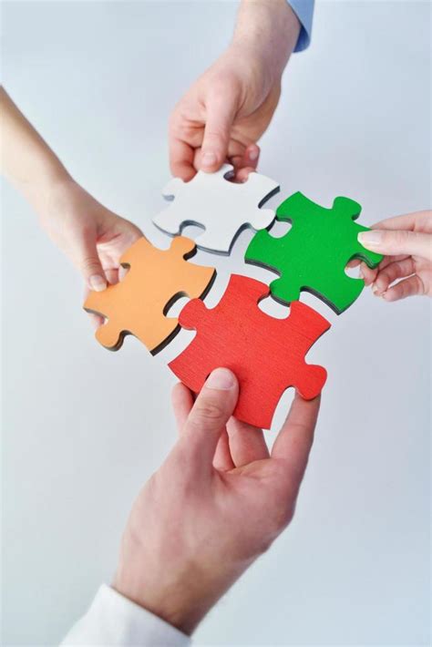 Group Of Business People Assembling Jigsaw Puzzle Stock Photo