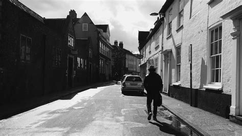 Premium Photo Rear View Of Silhouette Man Walking On Road Amidst