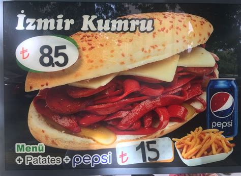 A Large Sandwich With Meat And Cheese On It Is For Sale In A Grocery Store