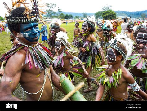 Children wearing traditional leaf costumes and dancing at the Goroka show in Papua New Guinea ...