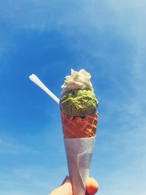 Premium Photo Midsection Of Person Holding Ice Cream