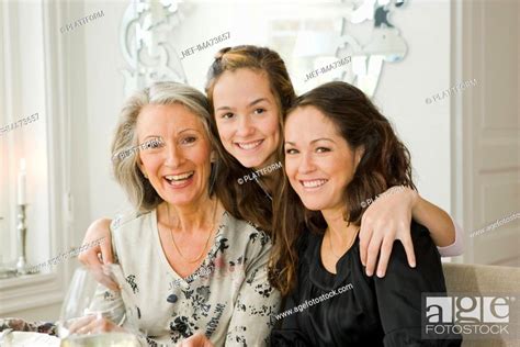 Portrait Of A Grandmother Daughter And Granddaughter At A Dinner Table