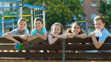 Glad Children Sitting On A Bench Stock Photo Image Of Girls Cute