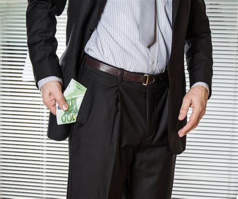 Premium Photo Midsection Of Businessman Holding Paper Currencies In