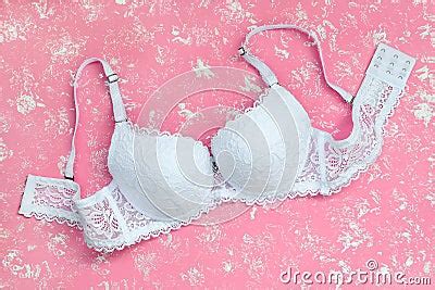White Lacy Bra On A Pastel Pink Background With White Spots Comfortable Modern Lingerie And