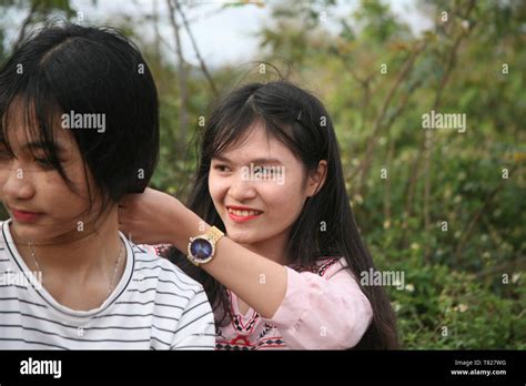 Photo Of A Girl Tying Her Friends Hair Stock Photo Alamy