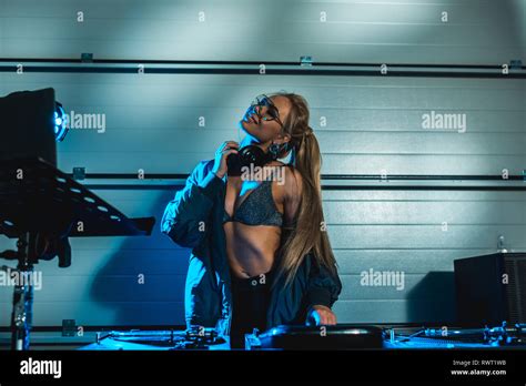Stylish Blonde Dj Woman Standing In Headphones And Glasses Stock Photo Alamy