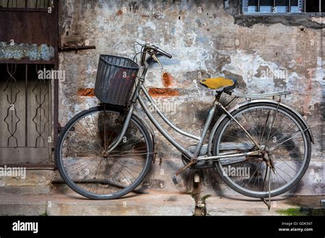 A Bicycle Parked In Front Of A House In Guangzhou China Stock Photo