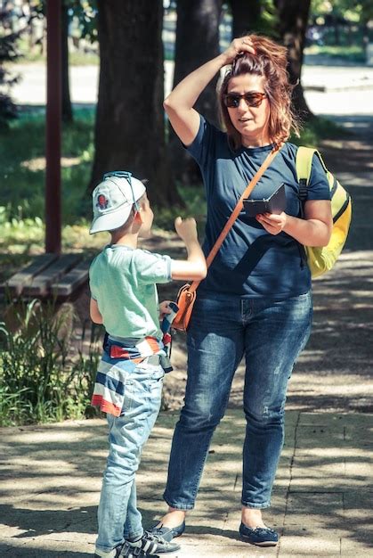 Premium Photo Full Length Of Mother And Son Standing Outdoors