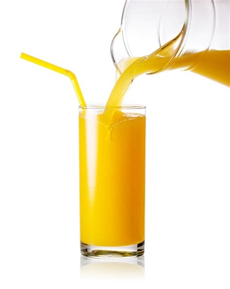 Premium Photo Orange Juice Pouring From Jug Into A Glass With Straw