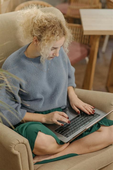 A Woman In Gray Sweater Typing On Laptop · Free Stock Photo