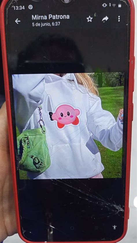 A Person Holding Up A Cell Phone With An Image Of A Pig On It