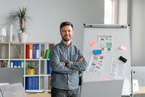 Confident Mature Businessman Making Project Presentation Demonstrating