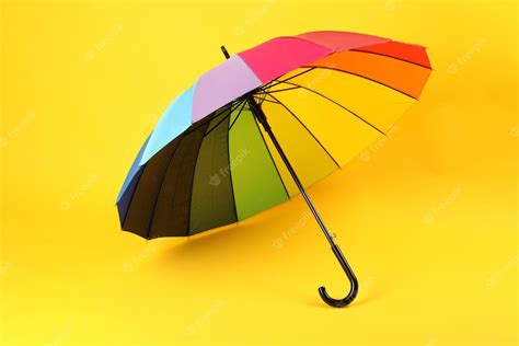 Premium Photo Umbrella Of Rainbow Color On Yellow Background