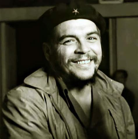 A Black And White Photo Of A Man With A Hat On Smiling At The Camera