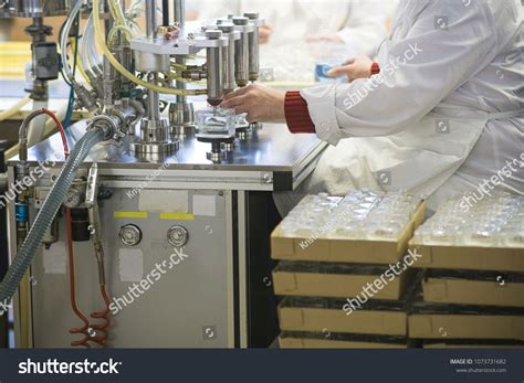 Manufacturing And Filling Perfume Bottles In A Factory Cosmetics Production Conveyor Line In An