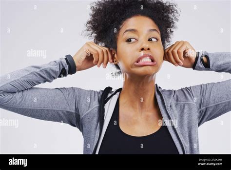 Funny Face Pulling Ears And An African Woman In Studio On A Gray