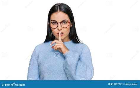 Young Hispanic Woman Wearing Casual Clothes And Glasses Asking To Be Quiet With Finger On Lips