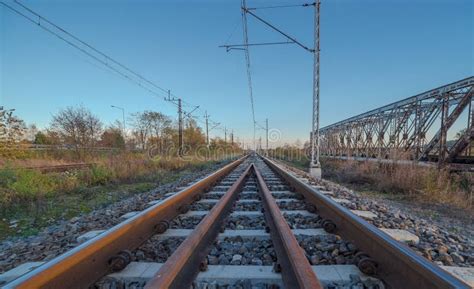 Railway Tracks Running Along The Road With A Historic Old Steel