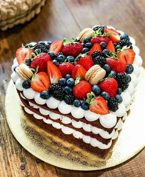 A Piece Of Cake With Berries And Nuts On Top