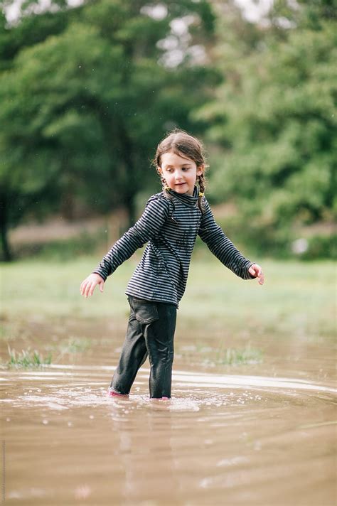 Preschool Age Girl In A Brown Puddle By Stocksy Contributor Gary