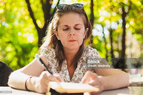 Woman Taking Notes Outside Stock Photo Download Image Now Author