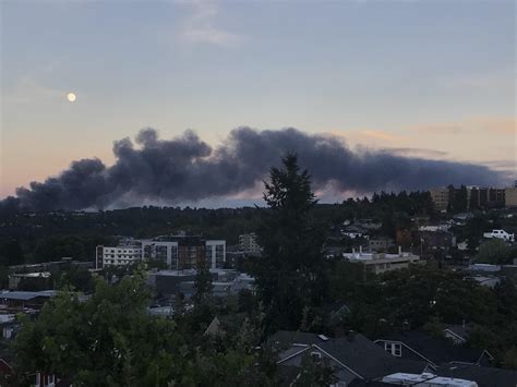 The moon above the smoke from a fire in West Seattle obscuring the