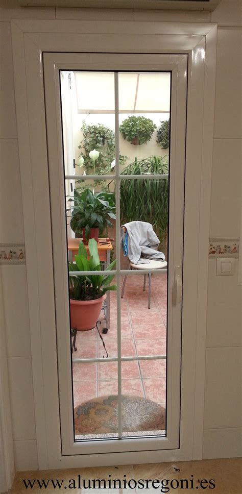 An Open Door Leading To A Patio With Potted Plants