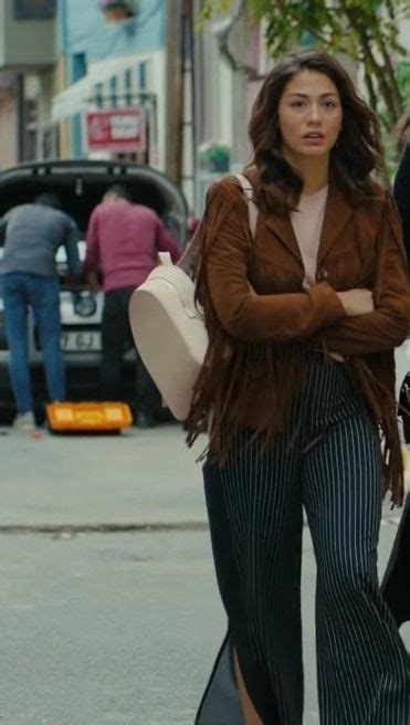 Two Women Are Walking Down The Street With Their Arms Crossed And One